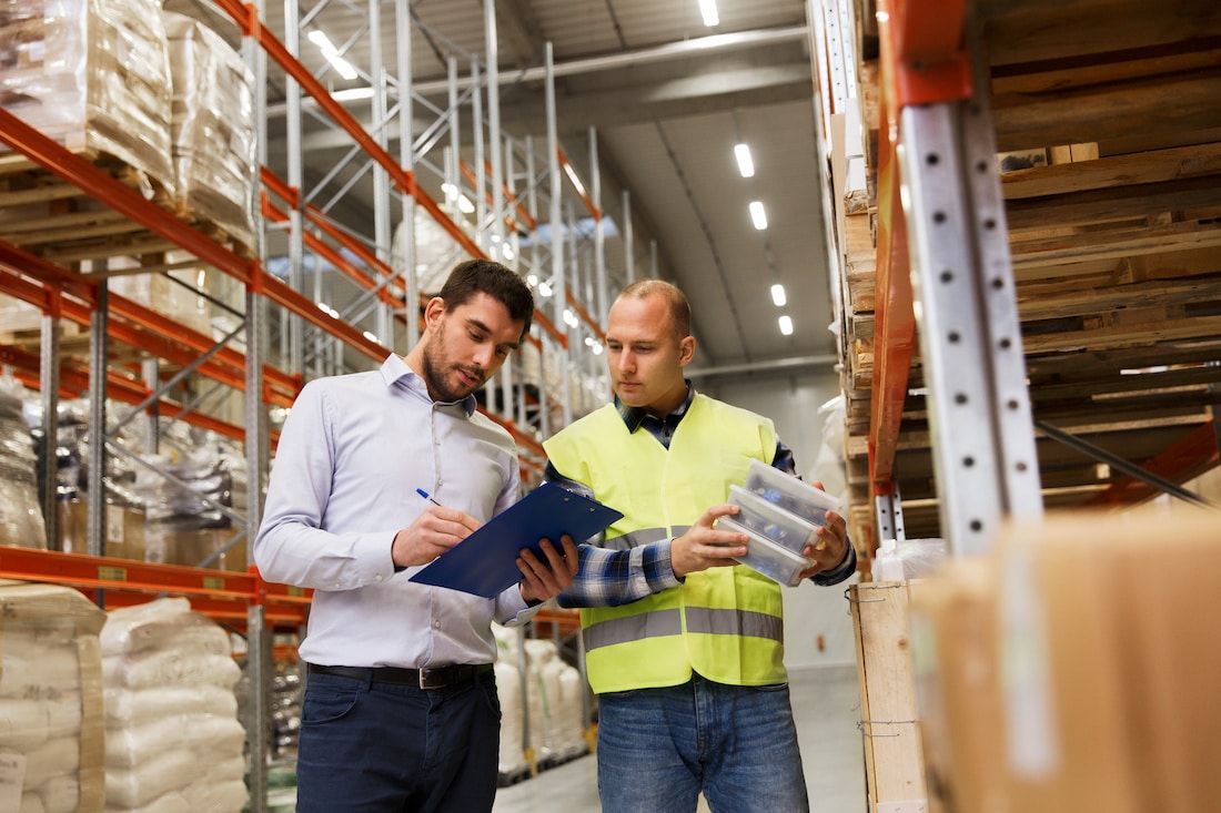 worker-and-businessmen-with-clipboard-at-warehouse